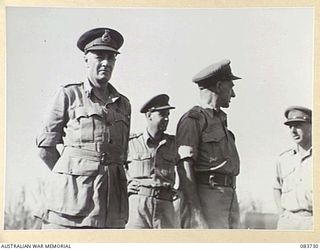 DRINIUMOR RIVER, NEW GUINEA. 1944-11-23. LIEUTENANT- COLONEL BAIRD, COMMANDER, ROYAL ENGINEERS 6 DIVISION, (AIF), (3), DISCUSSING ENGINEERING DIFFICULTIES WITH LIEUTENANT- GENERAL STURDEE, (1), AND ..