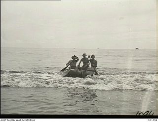 AITAPE, NORTH EAST NEW GUINEA. C. 1944-06. A SOUNDING PARTY OF NO. 13 SURVEY AND DESIGN UNIT RAAF SHOOT THE BREAKERS INTO THE BEACH IN A RUBBER BOAT, AFTER TAKING DEPTHS FOR A WHARF TO BE BUILT IN ..