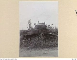 BUNA, NEW GUINEA, 1945-07-03 TO 1945-07-04. A KNOCKED OUT GENERAL STUART M3 TANK IN AN AREA OCCUPIED SUCCESSIVELY BY 2/9 AND 2/10 INFANTRY BATTALIONS