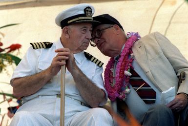 Retired CAPT Donald K. Ross, left, and retired CAPT Joseph K. Taussig Jr. confer during the Survivors Day program at the USS Arizona Memorial. The program is part of the observance of the 50th anniversary of the Japanese attack on Pearl Harbor. The two men were stationed aboard the battleship USS NEVADA on the day of the attack. For their actions on that day, Ross was awarded the Medal of Honor and Taussig the Navy Cross