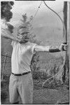 Edwin Cook practicing archery near his house in Kwiop