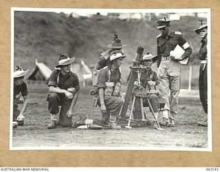 DONADABU, PAPUA, NEW GUINEA. 1944-01-01. PERSONNEL OF NO. 3 PLATOON HEADQUARTERS COMPANY MORTAR DETACHMENT COMPETING IN THE MORTAR SHOOT AT THE 15TH INFANTRY BRIGADE GYMKHANA. SHOWN ARE: VX7562 ..