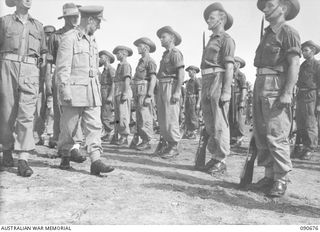 AITAPE, NEW GUINEA. 1945-04-17. MAJOR GENERAL J.E.S. STEVENS, GENERAL OFFICER COMMANDING 6 DIVISION (2), INSPECTING TROOPS OF 2/9 COMMANDO SQUADRON. THE PARADE WAS HELD IN UNIT LINES SHORTLY BEFORE ..