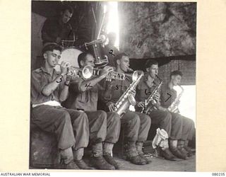 ALEXISHAFEN, NEW GUINEA. 1944-07. THE BRIGADE SWING BAND PARTICIPATING IN A CONCERT STAGED AT HEADQUARTERS 8TH INFANTRY BRIGADE, NORTH ALEXISHAFEN. IDENTIFIED PERSONNEL ARE:- NX120385 SERGEANT H. ..