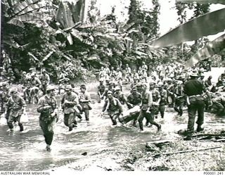THE SOLOMON ISLANDS, 1945-09-19. JAPANESE TROOPS FROM NAURU ISLAND MOVING ON AFTER REFRESHING THEMSELVES IN A STREAM DURING THEIR MARCH FROM TOROKINA TO AN INTERNMENT CAMP ON BOUGAINVILLE ISLAND. ..