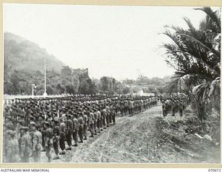 FINSCHHAFEN, NEW GUINEA, 1944-02-29. THE OFFICIAL OPENING OF THE FINSCHHAFEN WAR CEMETERY BY VX20308 MAJOR-GENERAL F.H. BERRYMAN, CBE, DSO, OFFICER COMMANDING 2ND AUSTRALIAN CORPS, WHO UNVEILED THE ..