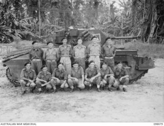 Group portrait of the Signal Troop, 2/4th Armoured Regiment. Left to right, back row: (six men in photograph by only five names supplied) VX86604 Signalman (Sig) W A Perry of Heathcote, Vic; ..