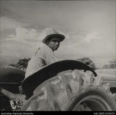 Farmer riding tractor