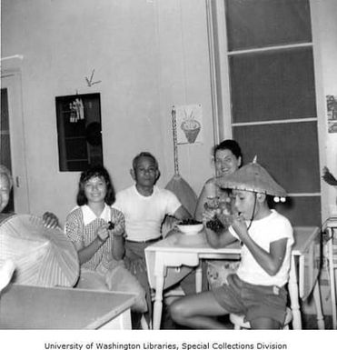 Mensalvas family and Tony sitting at kitchen table, Punaluu, September 1961