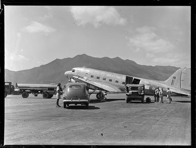 Tontouta Airfield and the unloading of a Dakota transport plane with unidentified personnel, New Caledonia