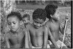 Children, one holding a stick