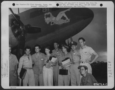 Gary Cooper and party pose with the crew of the Douglas C-47 "Lazy Lady" beside the plane at Port Moresby, Papua, New Guinea. 7 December 1943. The group includes: Una Merkle (fourth from left); Gary Cooper (fifth from left); Capt. V.K. Riggs (seventh (U.S. Air Force Number 67471AC)