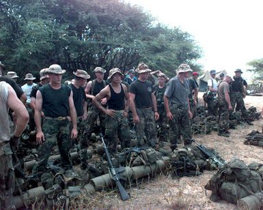 Members of the 1ST Marine Expeditionary Force, G-7, Tactical Exercise Contingency Group with M16 rifles and gear prepare to play the roll of rebel forces and provided resistance to US forces arriving from the sea during RIMPAC '96 taking place at Pacific Missile Range Facility, Barking Sands, Kauai, Hawaii