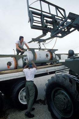 US Air Force personnel use a forklift to unload a Mark 52 air-delivered underwater mine from a pallet during Exercise TEAM SPIRIT'86