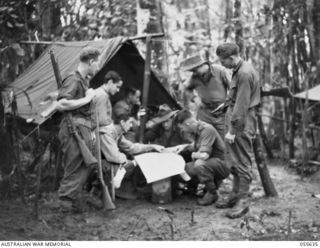 GOODVIEW, NEW GUINEA, 1943-08-10. TROOPS OF THE 2/6TH BATTALION CHECKING MAPS BEFORE GOING ON PATROL. LEFT TO RIGHT:- VX58014 PRIVATE (PTE) W. PEAT; VX58657 PTE A. COLLINS; VX7586 CAPTAIN H. MCL. ..