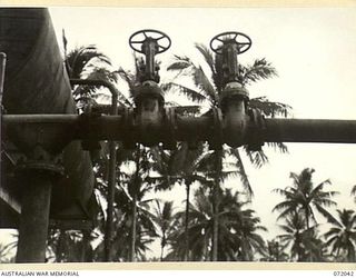 MILNE BAY, NEW GUINEA. 1944-04-04. THE ISOLATION VALVE USED TO PREVENT CONTAMINATION IN THE MAIN PIPE LINES BETWEEN AVIATION AND MOTOR SPIRIT AT THE 2ND AUSTRALIAN BULK PETROLEUM STORAGE COMPANY