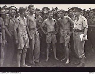 SOPUTA, NEW GUINEA. 1943-10-09. NX8 LIEUTENANT GENERAL SIR LESLIE MORSHEAD KCB KBE CMG DSO ED, GENERAL OFFICER COMMANDING 2ND AUSTRALIAN CORPS, RIGHT (1), CONGRATULATING MEMBERS OF THE 2/17TH ..