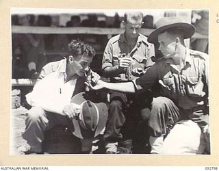 LAE, NEW GUINEA. 1945-06-09. PATIENTS OF 2/7 GENERAL HOSPITAL WAITING FOR AMBULANCES TO TRANSFER THEM TO THE HOSPITAL SHIP MANUNDA. IDENTIFIED PERSONNEL ARE:- PRIVATE F.G. TAYLOR (1); LEADING ..