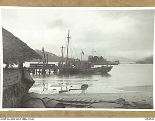 KWIARA, CHINA STRAITS, 1943-07-03. THE AK-60 OF THE 1ST AUSTRALIAN WATER TRANSPORT GROUP (SMALL CRAFT) UNLOADS SUPPLIES AFTER A RUN FROM PORT MORESBY