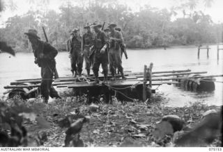 HANSA BAY-SEPIK RIVER AREA, NEW GUINEA. 1944-08-02. TROOPS OF THE 30TH INFANTRY BATTALION CROSSING THE BOT BOT RIVER BY MEANS OF A BARGE MADE FROM EMPTY JAPANESE OIL DRUMS. IDENTIFIED PERSONNEL ..