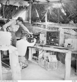 DUMPU, NEW GUINEA. 1944-01-11. VX20650 LANCE CORPORAL L. J. LEE (1) AND WX18026 SIGNALMAN N. C. WATT (2) OPERATING A 188 W/T TRANSMITTER IN THE 109TH TRANSMITTING STATION, 7TH DIVISION SIGNALS