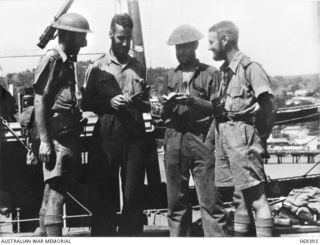 Port Moresby, New Guinea. 1942-04-12. The four officers of Lark Force of the Rabaul Garrison, photographed on the jetty in front of the HMAS Laurabada, the ship which evacuated 156 survivors from ..