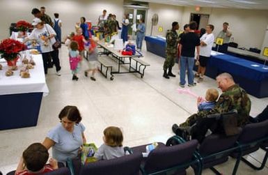 Hickam Air Force Base (AFB), Hawaii's Air Mobility Command (AMC) terminal is buzzing with family members from the island of Guam after a typhoon ravaged the little island