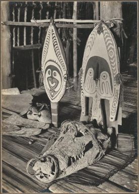 [Two masks and a crocodile skull, inside a Dubu] Frank Hurley