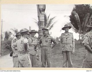 JACQUINOT BAY, NEW BRITAIN. 1945-03-29. LORD WAKEHURST, GOVERNOR OF NEW SOUTH WALES (5), ACCOMPANIED BY LADY WAKEHURST (3), AND LADY BLAMEY (1), MEETS BRIGADIER C.R.V. EDGAR, COMMANDING OFFICER, 4 ..