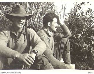 SHAGGY RIDGE, NEW GUINEA. 1944-01-10. 7308 CAPTAIN H. HOOK, ROYAL DECCAN HORSE (1) AND CAPTAIN A.J.C. STANTON, 14/20TH KINGS HUSSARS (2) TWO ENGLISH OFFICERS SERVING WITH "C" COMPANY, 2/9TH ..