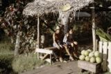 French Polynesia, people selling melons at roadside on Tahiti Island