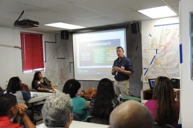 Individual Assistance Specialist Paul Parsons Jr., gives an overview of the FEMA Assessment process to a class of CNMI residents.