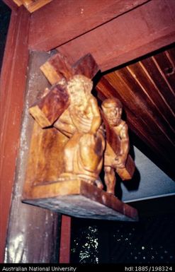 New Caledonia - detail of wooden sculpture with cross