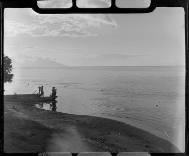 Papeete at sunset, Tahiti, showing two men with their boats