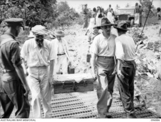 Internees boarding an Army landing barge for transfer to the motor launch Gloria. They are being evacuated from the Mission in Ramale Valley to Rabaul. Contact with the internees was made by Allied ..