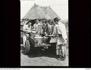 NADZAB, NEW GUINEA. C. 1944-02. AT NO. 24 MEDICAL CLEARING STATION RAAF A JEEP HAULS A TRAILER ROUND THE TENT WARDS WITH FOOD FOR THE PATIENTS AT LUNCH TIME