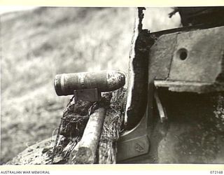 FORTIFICATION POINT, NEW GUINEA. 1944-04-08. A 75MM HOLLOW CHARGE JAPANESE SHELL PLACED IN POSITION AT THE FRONT ARMOUR OF A DISABLED MATILDA TANK DURING TESTS ARRANGED BY THE OPERATIONAL RESEARCH ..