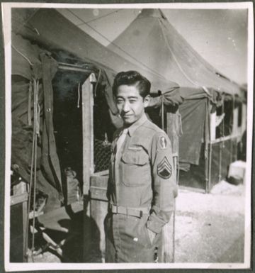 Soldier in front of tents