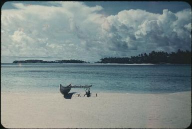 Islands of the atoll's ring, outrigger canoe on the beach : Mortlock Islands, Papua New Guinea, 1960 / Terence and Margaret Spencer