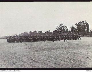 TOROKINA, BOUGAINVILLE. 1945-10-29. PERSONNEL OF AUSTRALIAN ARMY ORDNANCE CORPS MOVING TOWARDS THE SALUTING BASE WHERE THE COMMANDER IN CHIEF, AUSTRALIAN MILITARY FORCES, TAKES THE SALUTE DURING ..