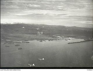 ALEXISHAFEN, NEW GUINEA. 1944-02-27. IN FLIGHT BESIDE THE COAST, VULTEE VENGEANCE DIVE BOMBER AIRCRAFT OF NO. 24 SQUADRON RAAF FORM UP TO RETURN TO NADZAB AFTER CARRYING OUT A BOMBING ATTACK ON THE ..