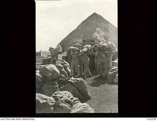 PAPUA-NEW GUINEA. C. 1942-12. RAAF POST OFFICE STAFF LOAD FOUR TONS OF PARCEL MAIL FOR RAAF UNITS AT AN ADVANCED BASE IN THE NEW GUINEA AREA. FLIGHT SERGEANT STAN GOSS OF LAUNCESTON, TAS, WHO IS IN ..
