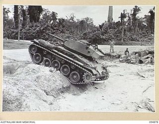 TOROKINA AREA, BOUGAINVILLE. 1945-08-08. AN M24 GENERAL CHAFFEE LIGHT TANK COMING DOWN INTO BED WHILE ATTEMPTING TO CROSS A WIDE WATERWAY DURING TRIALS CONDUCTED FOR THE WAR OFFICE