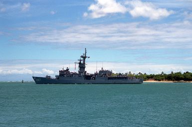 A port beam view of the frigate USS FRANCIS HAMMOND (FF-1067) departing Pearl Harbor through the channel.