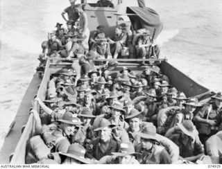 SIAR, NEW GUINEA. 1944-07-25. TROOPS OF THE 61ST INFANTRY BATTALION, CROWDED ABOARD A LANDING BARGE ON THE LAST LEG OF THEIR JOURNEY FROM MADANG ABOARD THE TRANSPORT SHIP (TS) "KATOOMBA". ..