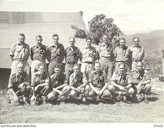 BULOLO, NEW GUINEA. 1944-07. OFFICERS OF THE 11TH DIVISION OUTSIDE THE UNIT "A" MESS. IDENTIFIED PERSONNEL ARE:- NX133183 CAPTAIN H.L. TAYLOR, PAYMASTER (1); NX113170 CAPTAIN W.G.C. O'NEILL OFFICER ..