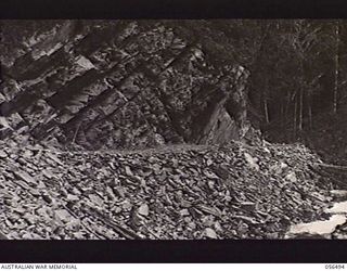 REINHOLD HIGHWAY, NEW GUINEA, 1943-08-31. ROCK FACE AT THE 26 MILE POINT ON THE HIGHWAY