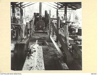 BUSU FOREST, LAE AREA, NEW GUINEA. 1944-07-26. THE STEAM ENGINE WITH BELT DRIVES WHICH SUPPLIES PART OF THE POWER AT THE 2/3RD FORESTRY COMPANY, ROYAL AUSTRALIAN ENGINEERS