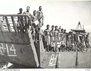 JACQUINOT BAY, NEW BRITAIN. 1944-12-01. AUSTRALIAN NEW GUINEA ADMINISTRATIVE UNIT NATIVES BEING TAKEN TO WORK IN THE 5TH AUSTRALIAN DIVISION CAMP AREA ABOARD AN LANDING CRAFT MECHANISED (LCM) OF B ..