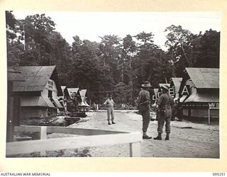 JACQUINOT BAY, NEW BRITAIN, 1945-08-11. A GENERAL SCENE AT 5 DIVISION RECEPTION CAMP LOOKING TOWARDS THE ENTRANCE WITH OFFICER COMMANDING CAPTAIN J.H. SMITH FACING CAMERA